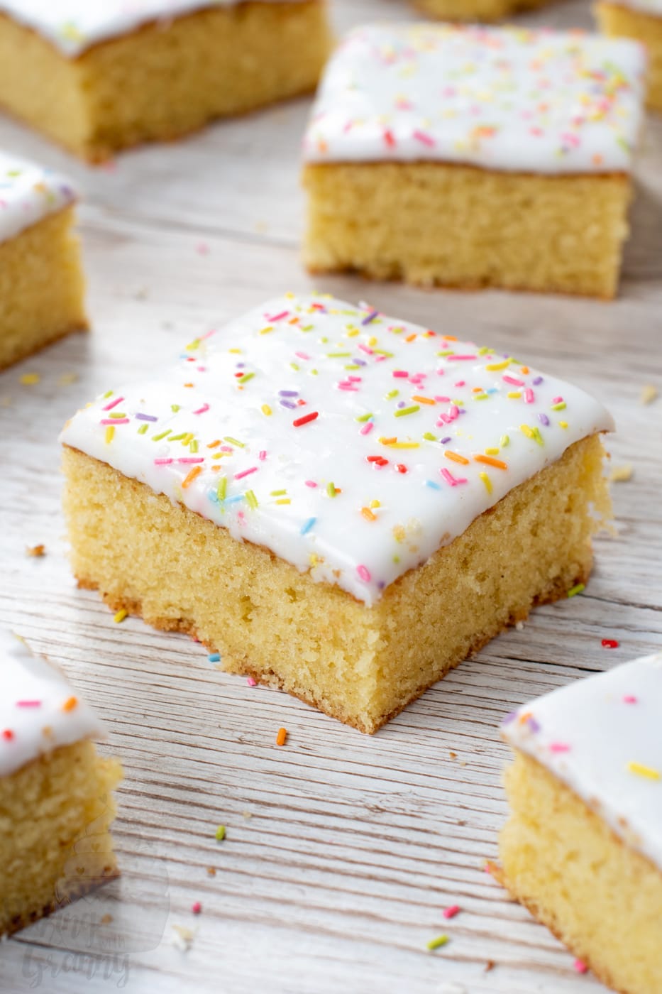 School Cake recipe by Baking with Granny. Sponge cake with white icing and rainbow sprinkles.